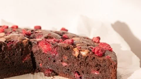 Delicious Chocolate Raspberry Cake topped with fresh raspberries and chocolate ganache.