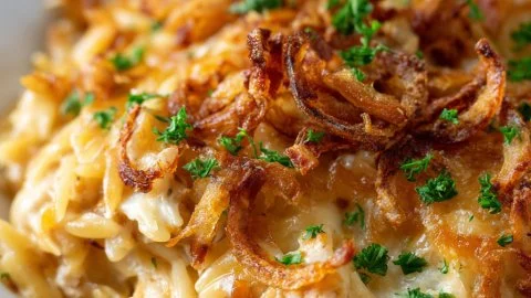 French onion chicken orzo casserole topped with melted cheese.