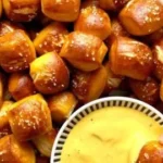 Plate of soft and warm pretzel bites served with dipping sauce