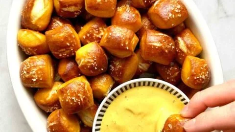 Plate of soft and warm pretzel bites served with dipping sauce