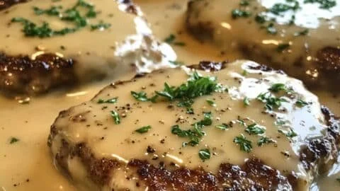 Amish Hamburger Steak Bake served on a plate with side dishes