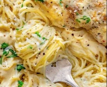 Crock Pot Angel Chicken served with creamy sauce and herbs