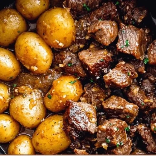 Garlic Butter Beef Bites with Potatoes served in a skillet