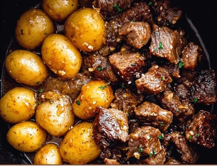 Garlic Butter Beef Bites with Potatoes served in a skillet