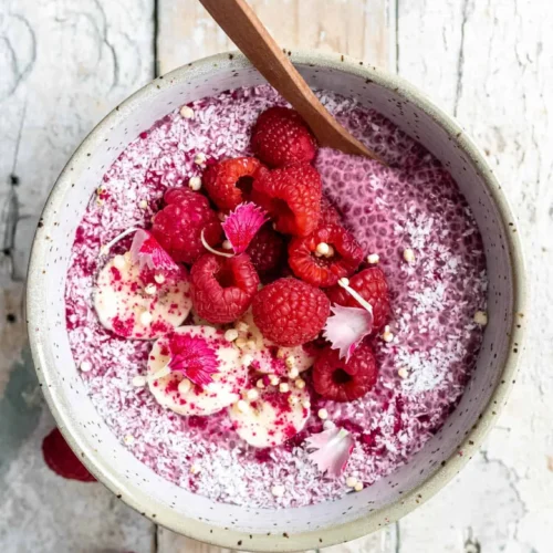 Delicious raspberry chia pudding topped with fresh raspberries and mint leaves