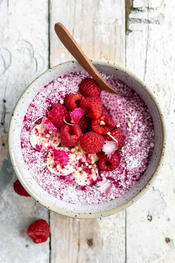 Delicious raspberry chia pudding topped with fresh raspberries and mint leaves