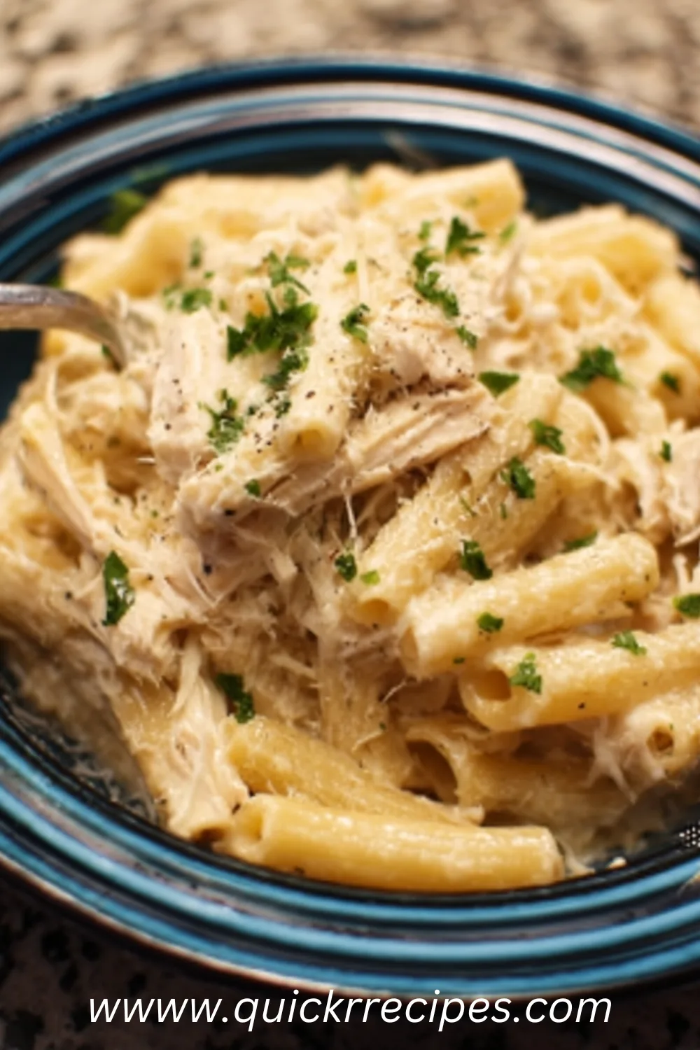 Crockpot Chicken Alfredo fresh from the slow cooker with creamy sauce, pasta, chicken, and parsley